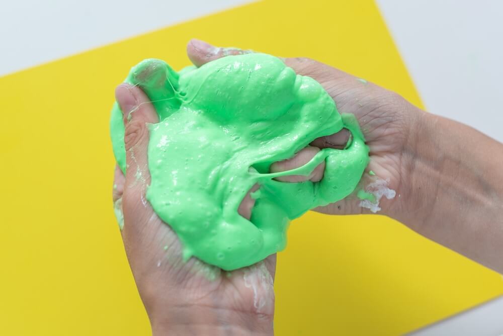 Zielony slime w dłoniach