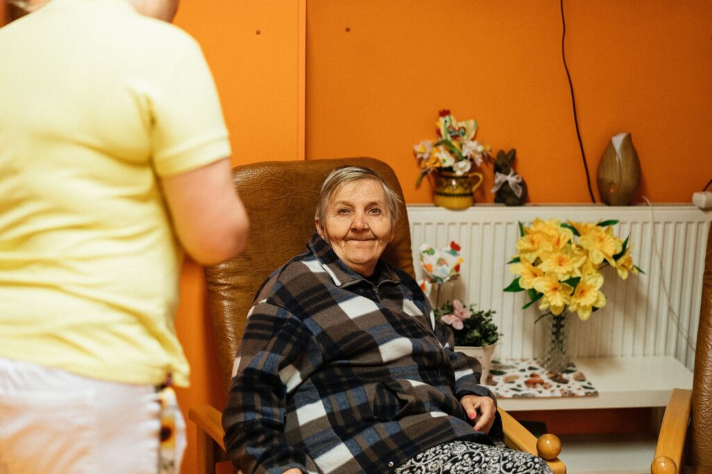 Starsza kobieta siedząca w fotelu